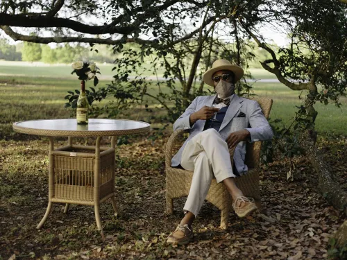 man in a chair wearing a mask outside