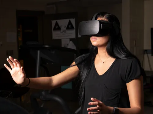 Student interacting with VR headset