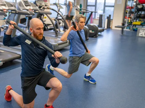 student showing client proper lifting technique