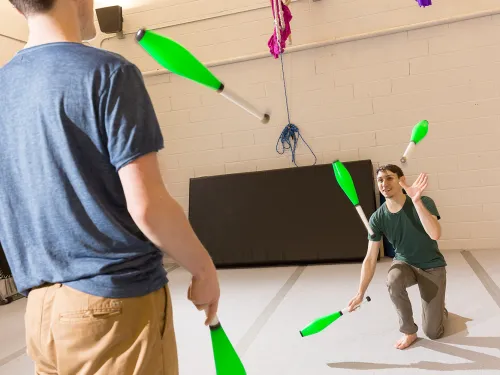 Students juggling pins together.