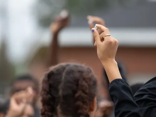 Students holding a pebble
