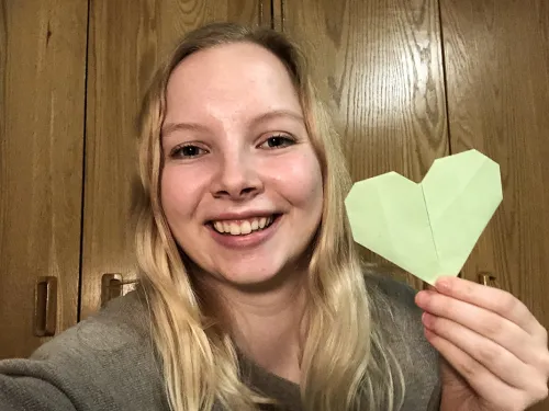 Eleanor Kay ’23 holding an origami heart