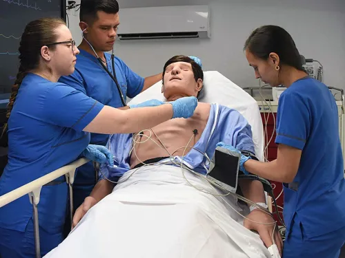 students with a patient care manikin