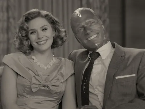 Wandavision actors sitting on a couch