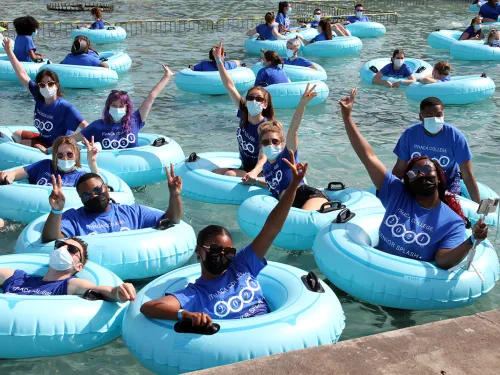 students in the fountains in inner tubes