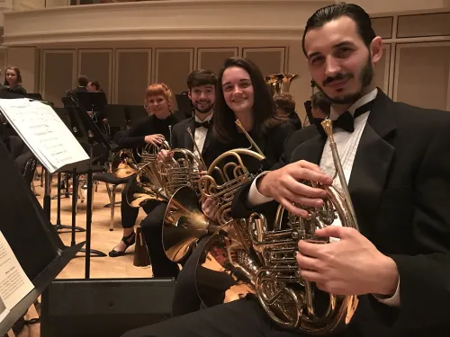 Patrick Holcomb ’18 holding a horn
