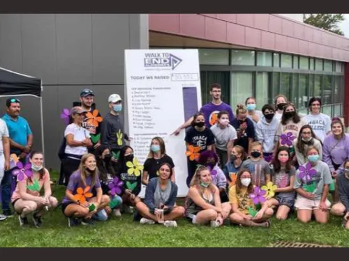 Group in front of a sign