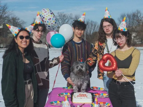 five band members at a table