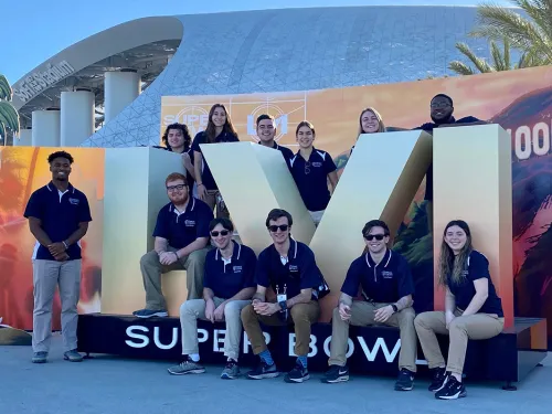 Students in front of the SB LVI logo