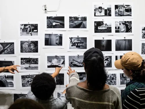 Students looking at photographs on the wall