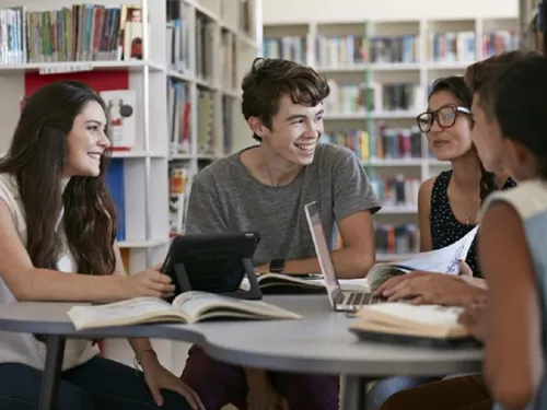people at a table with books
