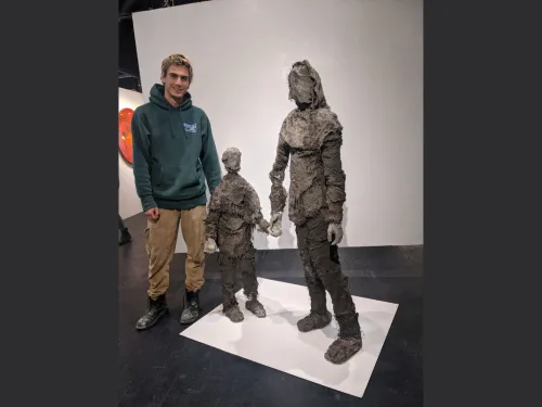 Andrew Lackland Standing next to their structures.