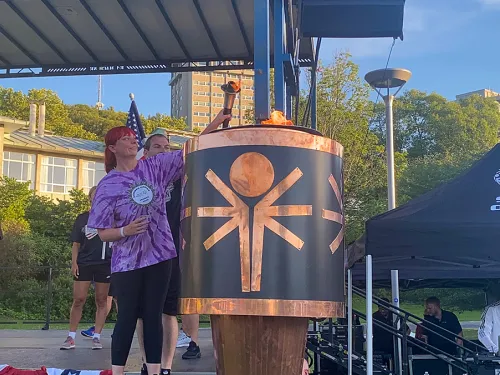 Special Olympic athletes lighting the torch