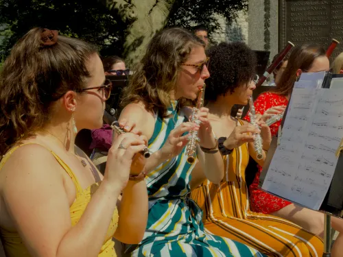 three women each playing a flute