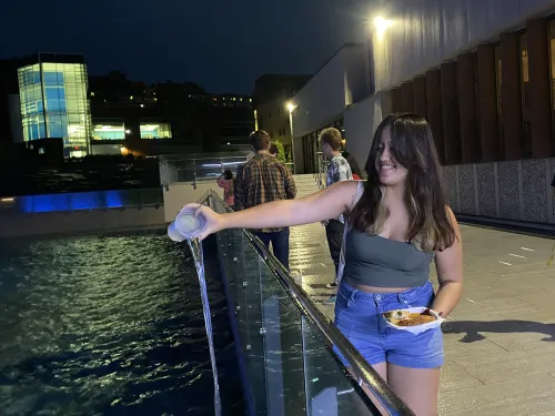 Student pouring water into the Fountains