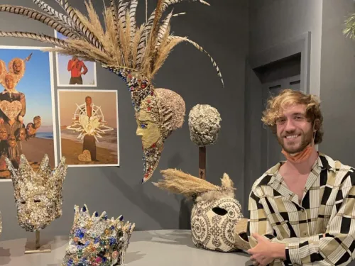 Mike Sullivan standing in front of several of his masks