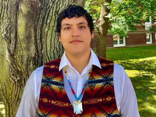 Victor A. Lopez-Carmen standing against a tree