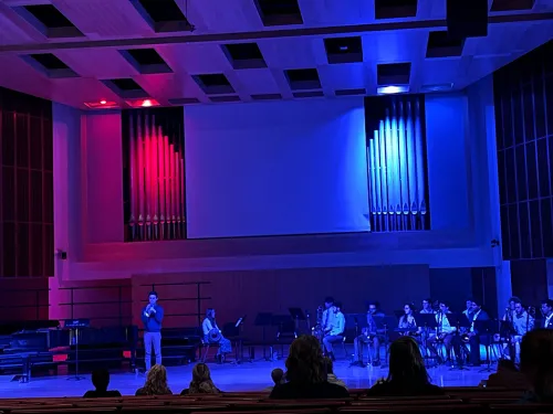 Student playing a trumpet on stage