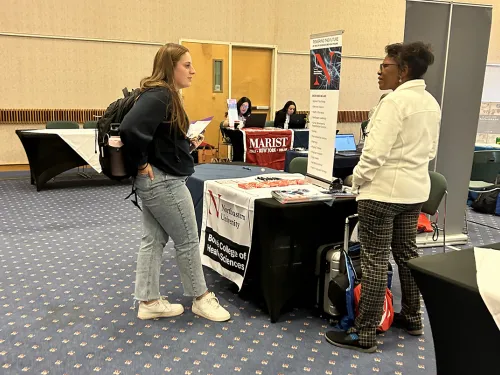 A student at a table getting information