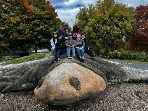 Students sitting on a turtle