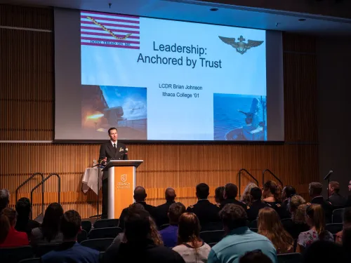 A person is providing a presentation on Leadership Anchored by Trust