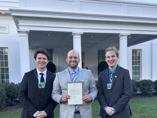 Students and Jeremy Menard in front of the White House