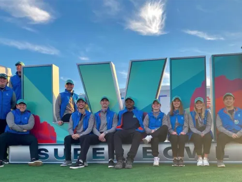 Students in front of the SB logo