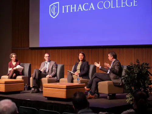 The four panelists on a stage