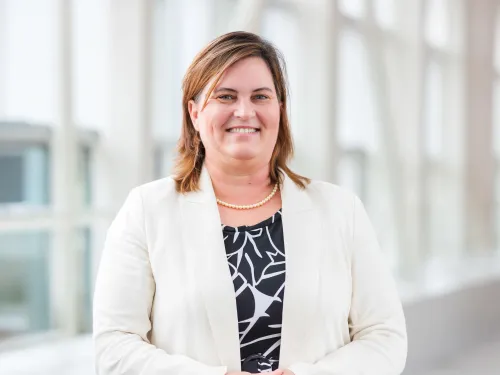 woman standing in front of windows
