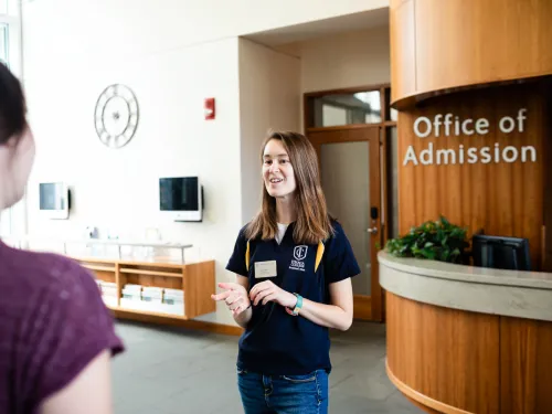 Ithaca College admission host greets a student