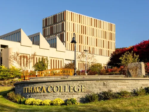 entrance sign with Dillingham Center in the background