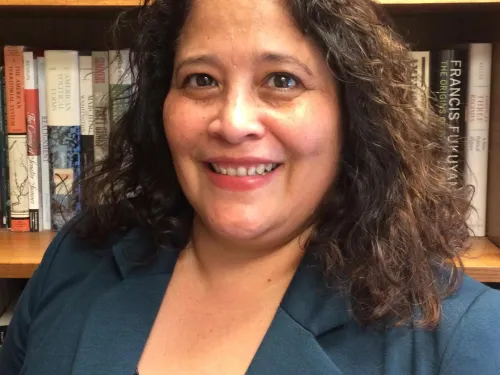 woman in front of bookshelf