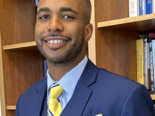 man wearing a blue suit with yellow tie