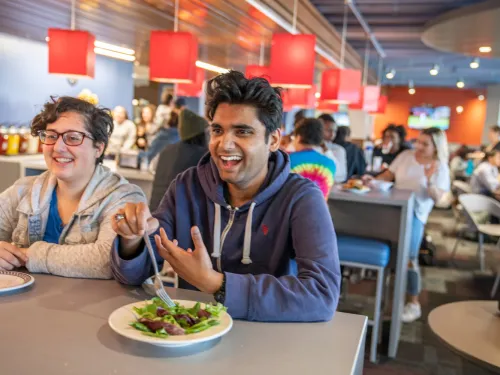 two students enjoy a meal together
