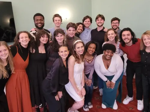 a group of students poses with their professor