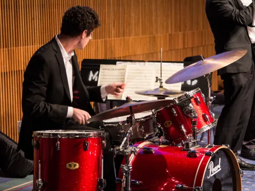 person playing drum set