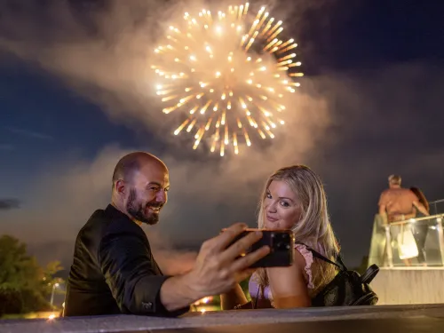 People taking a photograph of fireworks