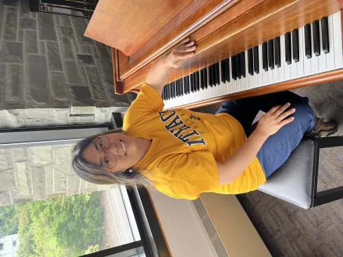 Photo of Melody sitting at a piano