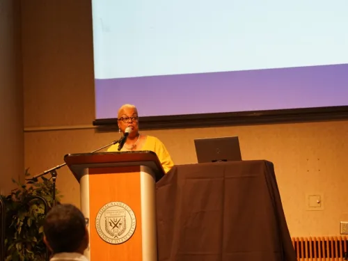 A woman speaks at a podium. 