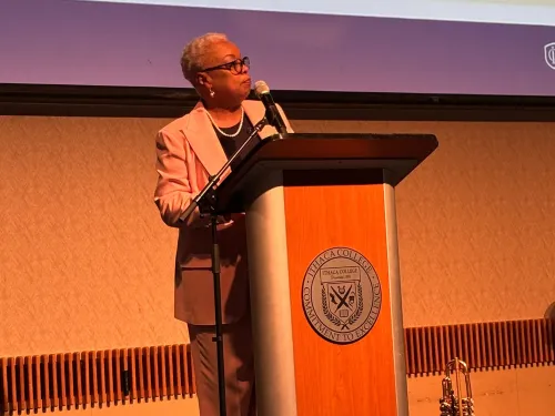 A woman speaks at a podium. 