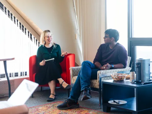 two students sit and talk