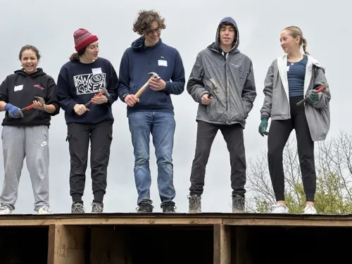 Scholars building a roof to a shelter for Youth Farm Project