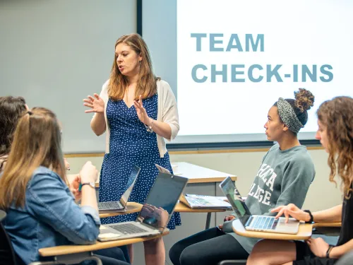 Faculty leads a team check-in.