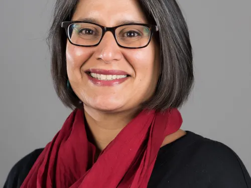 Profile picture of women with dark hair and glasses