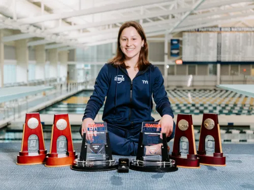 A college athlete displays her diving trophies. 