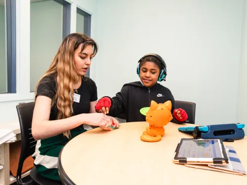 speech language student works with a teenage patient 