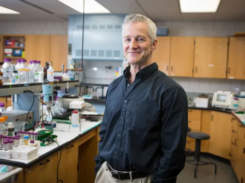 man wearing a dark shirt in a laboratory