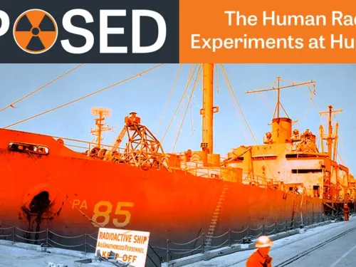 Orange ship at a dock.