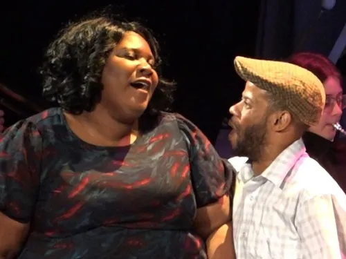 two students sing together 