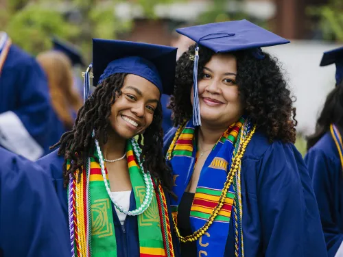 Two graduates pose for a picture